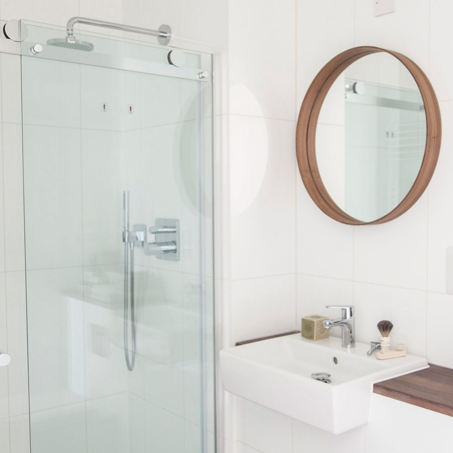 image of clean bathroom sink and shower area.